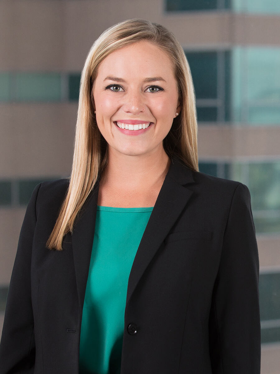 Alison Zeitlin, woman with long blonde hair, wearing black blazer over green shirt