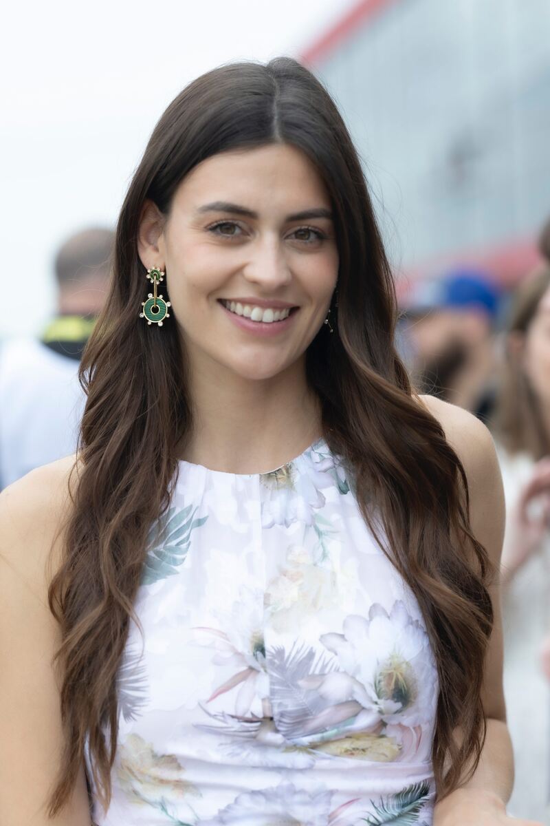 Ashlyn Moore, woman with long dark hair, wearing flowered dress