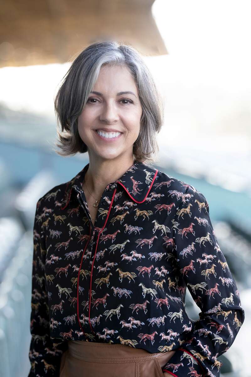 Woman in black shirt with colored horse pattern