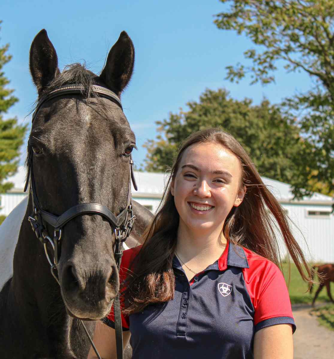 Dark haired woman next to horse