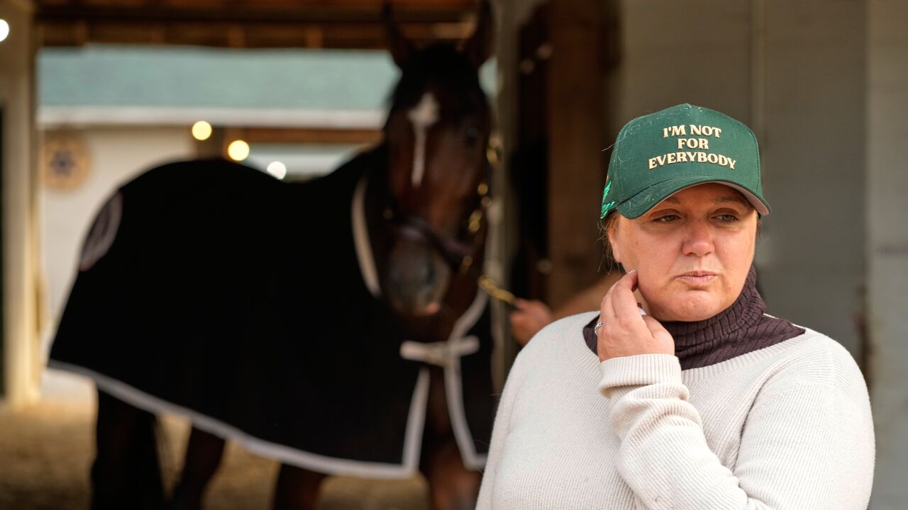 cherie deveaux with green baseball hat standing in front of Golden Tempo
